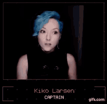 a woman with blue hair is wearing a black tank top and making a funny face .