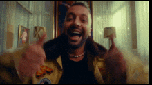 a man with a beard is wearing a yellow jacket with a patch on it that says ' army ' on it