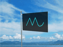 a black flag with the letter m on it is flying in the wind