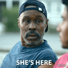 a man wearing a hat says she 's here in a netflix ad