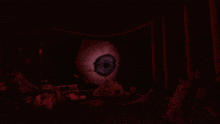 a large eye in the dark with a red background