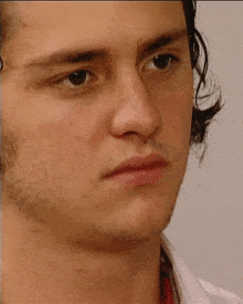 a close up of a young man 's face with a beard