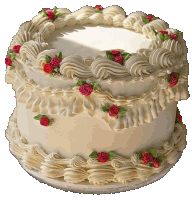 a white cake with red roses and green leaves on it