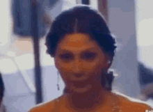 a close up of a woman 's face with a blurred background and a blurry background .