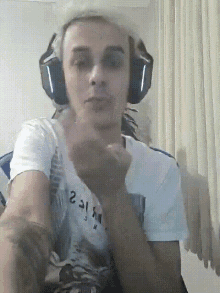 a man wearing headphones and a t-shirt that says ' 2 31 ' on it