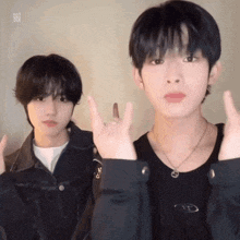 two young men are making devil horns signs with their fingers