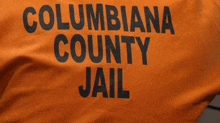 columbiana county jail is printed on the back of an orange shirt