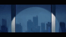 a city skyline is reflected in a glass window