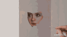 a person is painting a woman 's face with a brush on a canvas .
