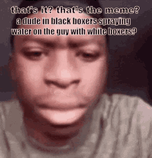 a man is spraying water on another man with white boxer 's