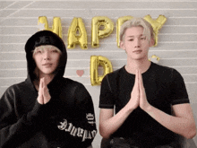 two men praying in front of balloons that say happy day