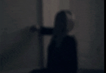 a blurry picture of a woman in a black jacket