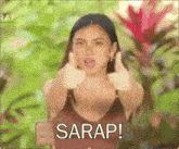 a woman in a bikini is giving a thumbs up with the words sarap written below her