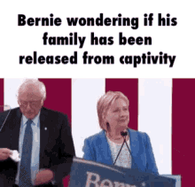 bernie wondering if his family has been released from captivity while hillary is giving a speech .
