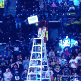a man on a ladder holds a sign that says money bank