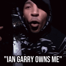 a man wearing a black ufc hoodie says " ian carry owns me "