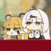 a couple of anime girls are sitting next to each other on a red table .