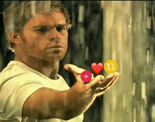 a man in a white shirt is holding a red heart and a yellow circle with arrows pointing up and down