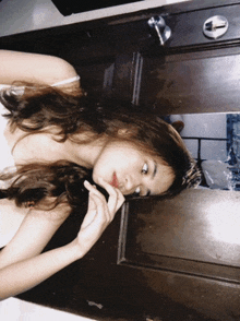 a woman is looking at herself in a mirror