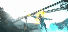 a man in a superhero costume is flying through the air while holding a sword .