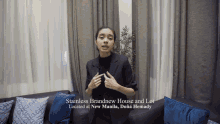 a woman sitting on a couch with the words stainless brandnew house and lot located at new manila doña hemady