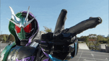a person in a purple and green costume holds a gun