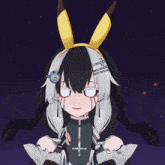 a girl with a cross on her chest is wearing a headband with bunny ears