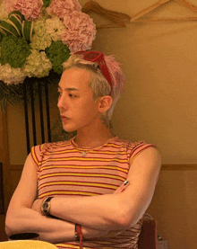a man wearing a striped shirt and a red headband with the letter s on it