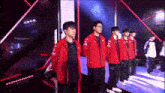 a group of young men are standing next to each other on a stage .