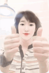 a woman giving a thumbs up sign with her hands