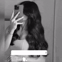 a woman is taking a picture of herself in a mirror with her phone