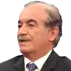 a man with a mustache wearing a suit and tie looks at the camera
