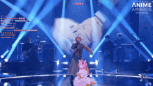 a woman singing on a stage with the words anime awards written on the bottom