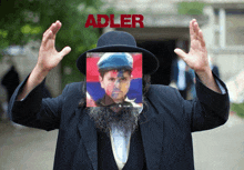 a man with a beard wearing a hat and a picture of a man with the word adler above him