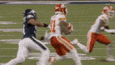 a football player with the number 31 on his jersey is running on the field .
