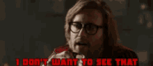 a man wearing glasses and a red vest says i don 't want to see that