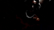 a close up of a person 's face with a knife in their mouth .