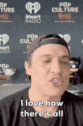 a man says " i love how there 's all " while wearing a baseball cap