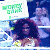 a woman in a boxing ring is holding a money bank