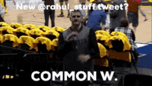 a man is standing in front of a row of yellow seats with the caption " new @rahul stuff tweet common w. "