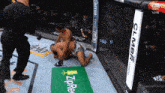 two men are wrestling in a ring with a sign that says zipre on it