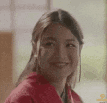 a close up of a woman 's face with a smile on her face .