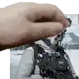 a close up of a person 's hand holding a picture of a soldier in the snow .