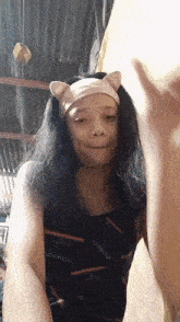 a woman wearing a headband with ears and a gucci shirt
