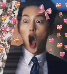 a man in a suit and tie with a pink bow on his head is surrounded by hearts