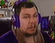 a man wearing purple headphones and a purple robe .