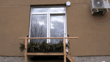 an lg air conditioner is mounted on the side of a building next to a window