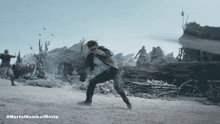 a mortal kombat movie poster shows a man fighting a group of men