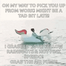 a man is sitting on a unicorn float in the water .