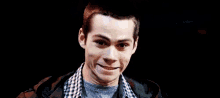 a close up of a man making a funny face with his mouth open .